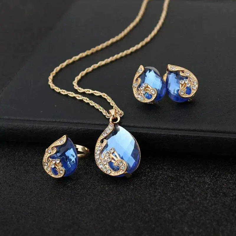 Ensley | Blue Crystal Necklace + Earring Set in Blue Crystal in Gold